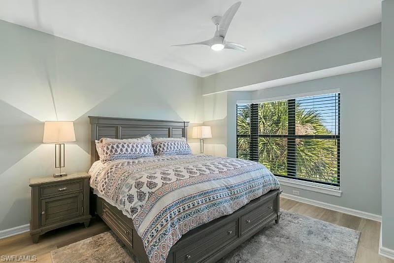 310 La Peninsula Boulevard, Unit 310 Naples, FL 34113 - Photo 20 of 27 a bedroom with a large bed and a window