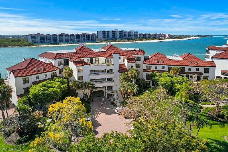 310 La Peninsula Boulevard, Unit 310 Naples, FL 34113 - Photo 2 of 27 an aerial view of a house with a garden