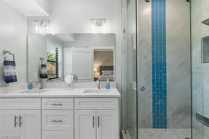 310 La Peninsula Boulevard, Unit 310 Naples, FL 34113 - Photo 21 of 27 a bathroom with a sink and a mirror