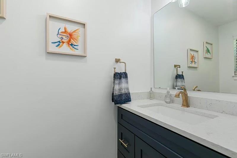 310 La Peninsula Boulevard, Unit 310 Naples, FL 34113 - Photo 22 of 27 a bathroom with a sink and a mirror