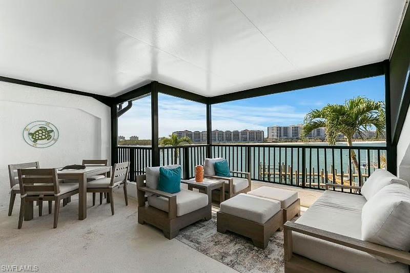 310 La Peninsula Boulevard, Unit 310 Naples, FL 34113 - Photo 23 of 27 a living room with furniture