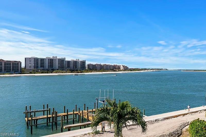 310 La Peninsula Boulevard, Unit 310 Naples, FL 34113 - Photo 24 of 27 a view of a lake with a city