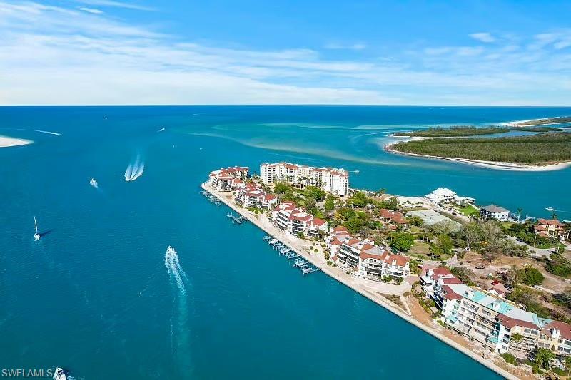 310 La Peninsula Boulevard, Unit 310 Naples, FL 34113 - Photo 26 of 27 a view of a lake from a balcony