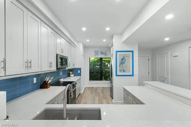 a view of a living room and kitchen