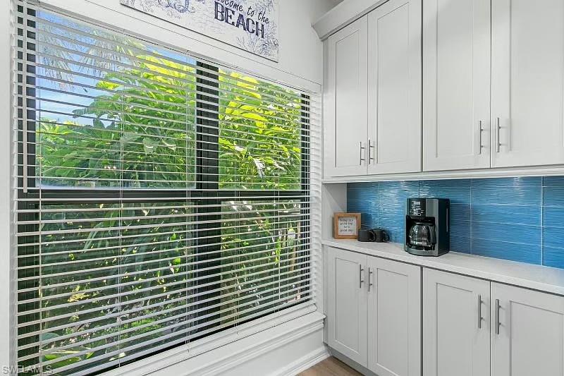 310 La Peninsula Boulevard, Unit 310 Naples, FL 34113 - Photo 7 of 27 a kitchen with a window and cabinets