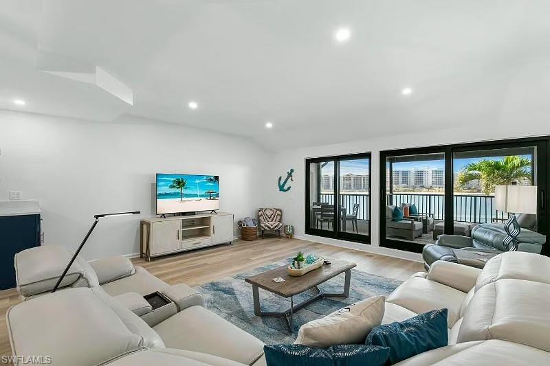 310 La Peninsula Boulevard, Unit 310 Naples, FL 34113 - Photo 10 of 27 a living room with furniture flat screen tv and a large window