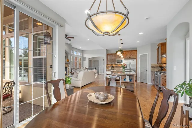 a view of a dining room with furniture and a chandelier