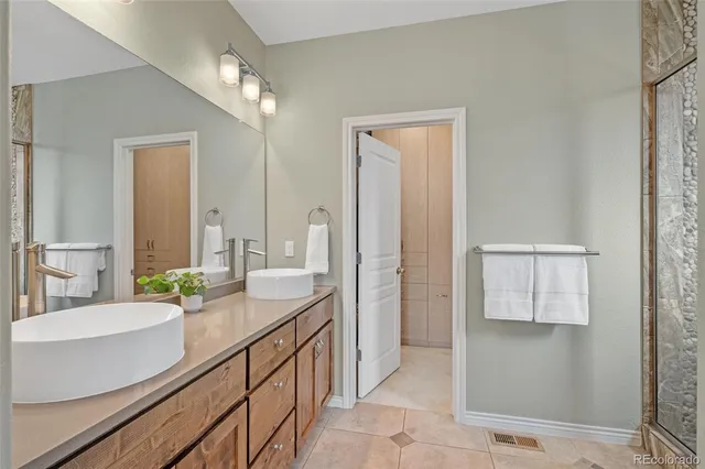 a bathroom with a double vanity sink and a mirror