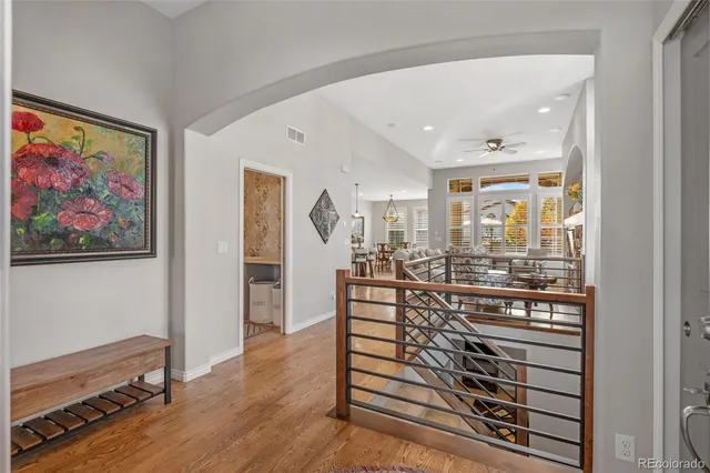 a view of a hallway with wooden floor and furniture