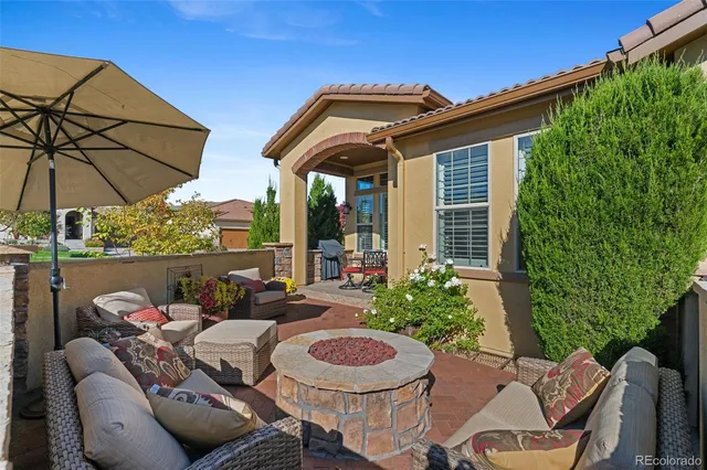 a view of a house with patio and a yard