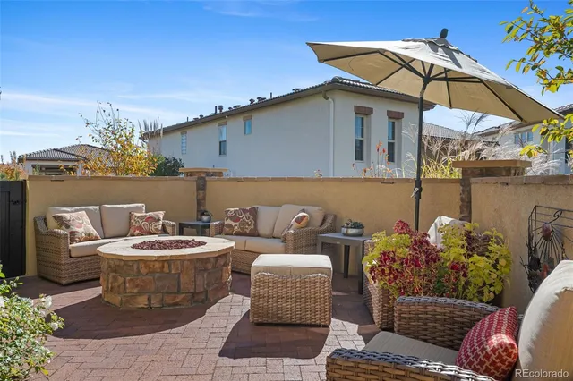 a balcony with furniture and a potted plant