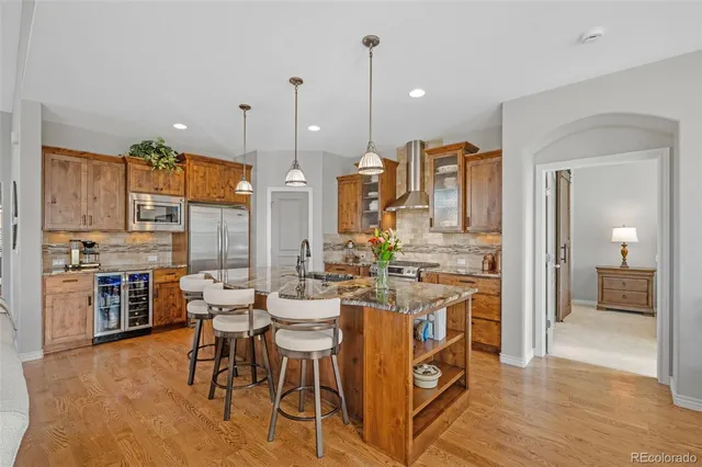 a large kitchen with a table and chairs