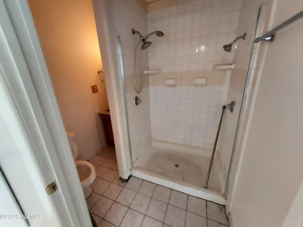 a bathroom with a glass door shower