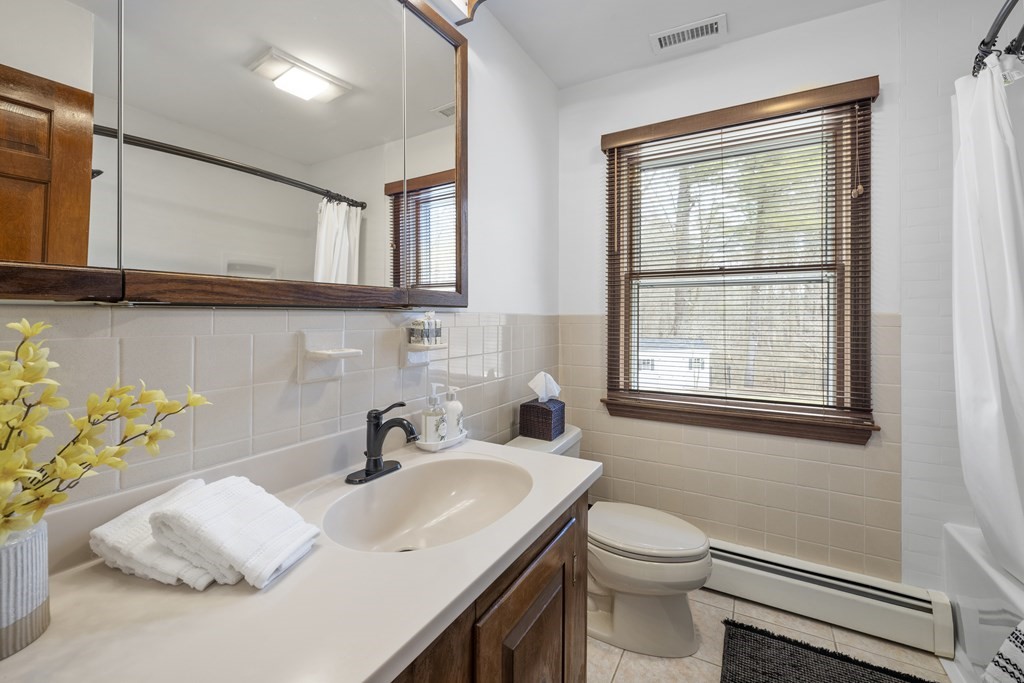 270 Middleton Road Boxford, MA 01921 - Photo 17 of 40 a bathroom with a sink vanity mirror and toilet