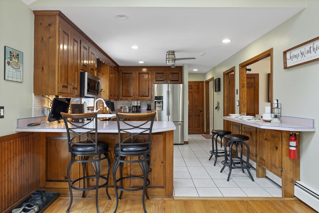270 Middleton Road Boxford, MA 01921 - Photo 26 of 40 a kitchen with stainless steel appliances kitchen island granite countertop a refrigerator and cabinets