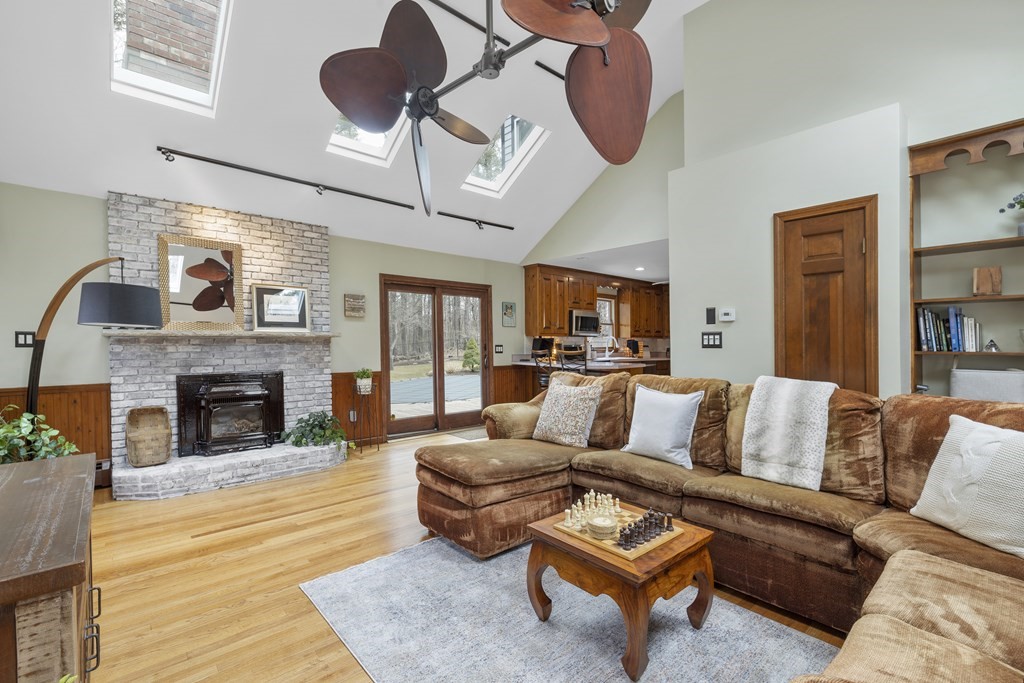270 Middleton Road Boxford, MA 01921 - Photo 29 of 40 a living room with furniture a fireplace and a flat screen tv