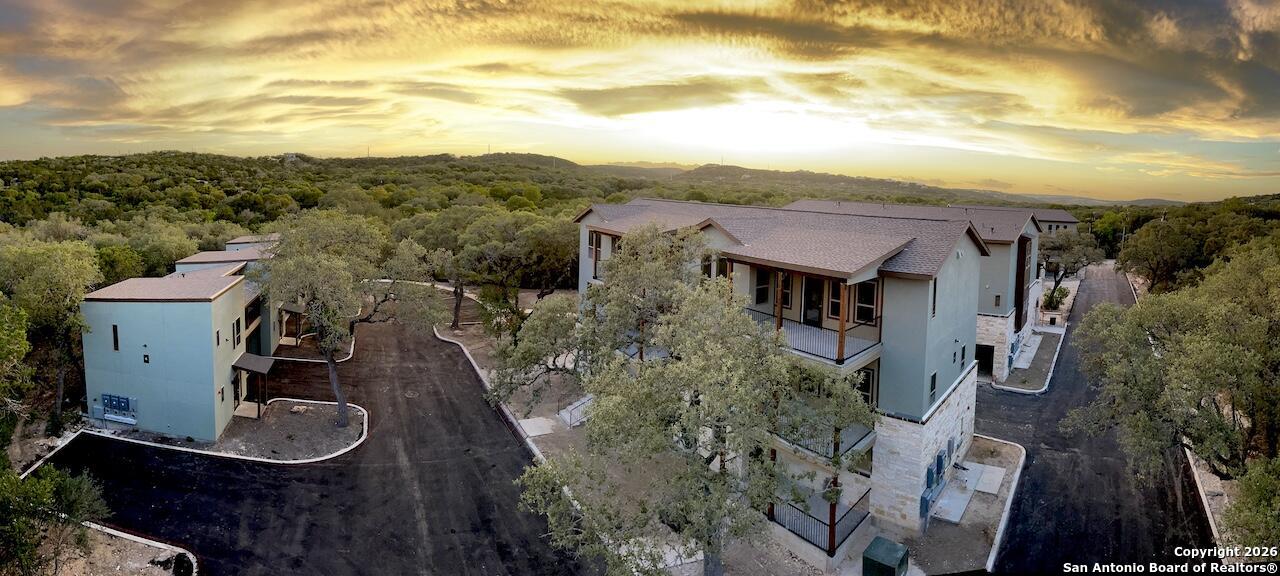 a view of a house with a yard and mountain view