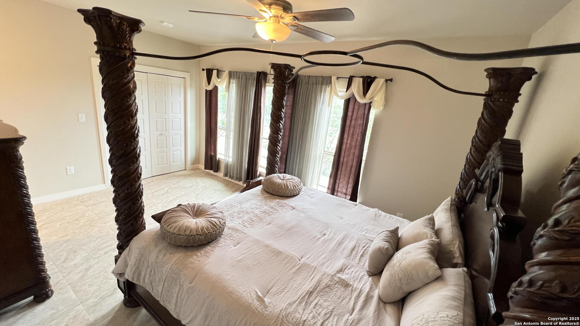 14743 Old Bandera Road, Unit 4 Helotes, TX 78023 - Photo 6 of 7 a bedroom with a bed and a chandelier