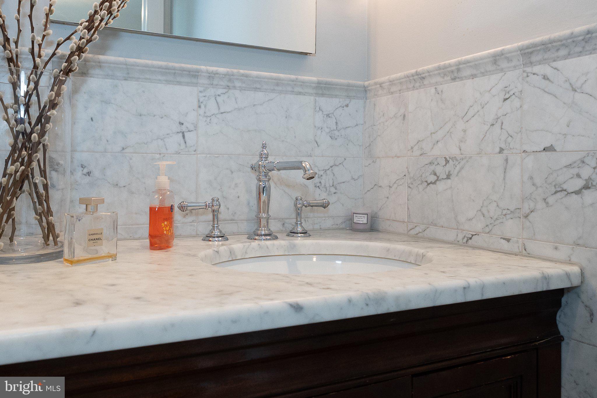 17 Gevrey, Unit 17 Devon, PA 19333 - Photo 19 of 33 Rich stone and tile vanity has undermount sink