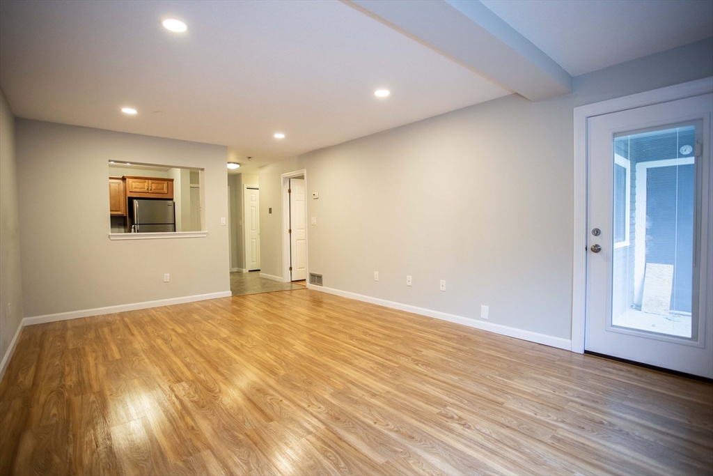 500 Colonial Drive, Unit 3 Ipswich, MA 01938 - Photo 5 of 23 a view of an empty room with wooden floor and closet