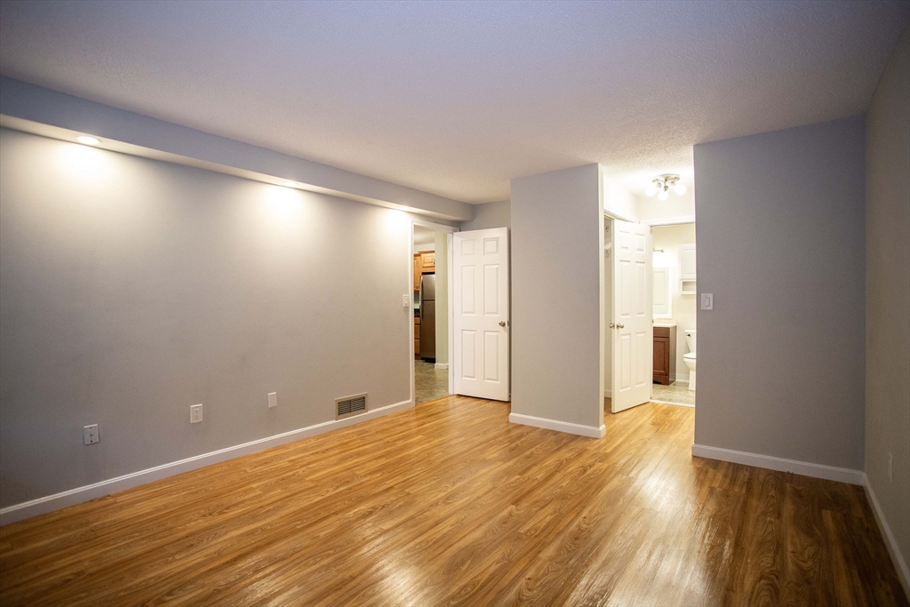 500 Colonial Drive, Unit 3 Ipswich, MA 01938 - Photo 7 of 23 a view of an empty room with wooden floor