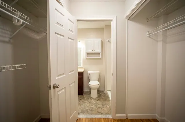 a bathroom with a granite countertop shower and a toilet