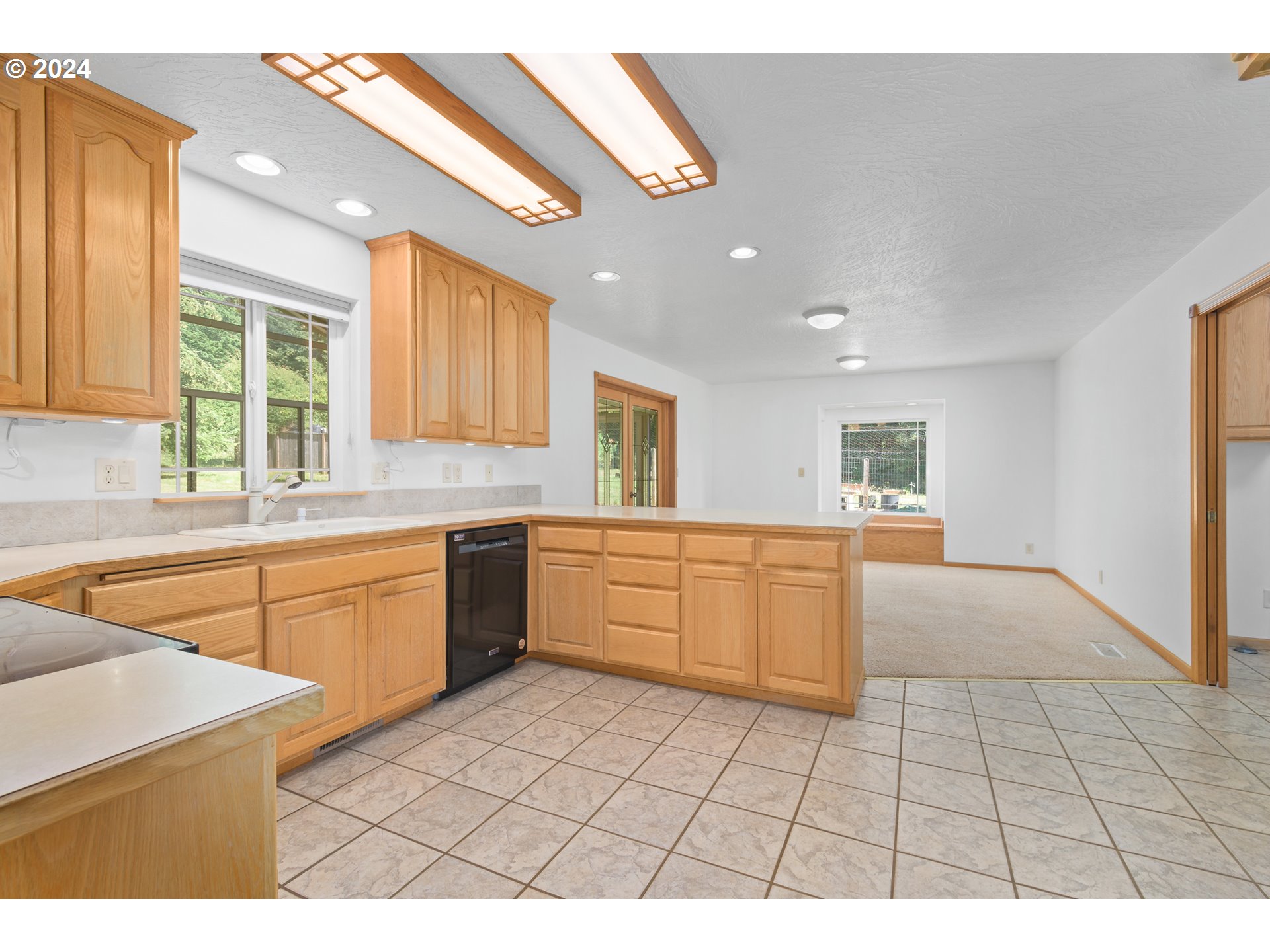 89584 Demming Road Elmira, OR 97437 - Photo 7 of 32 a kitchen with a sink a stove cabinets and a window