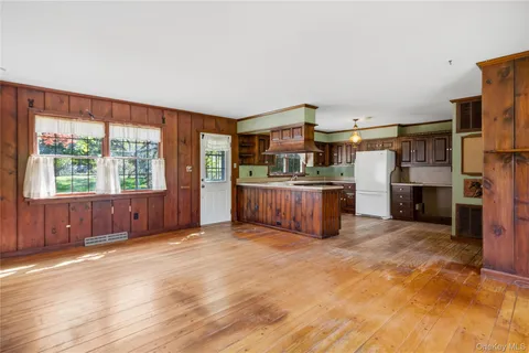 a view of kitchen with furniture and a fireplace