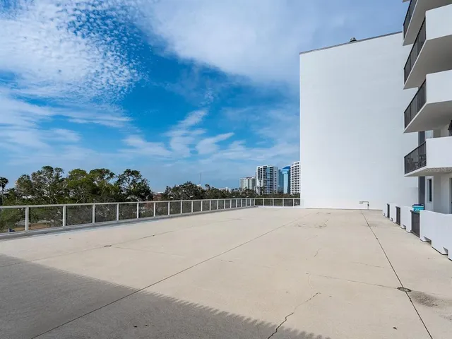 a view of a swimming pool with a chairs and table in the terrace