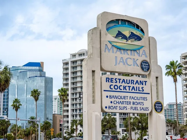 a view of a ocean with boats and trees in the background