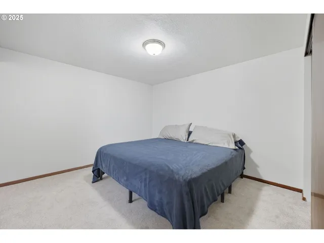 a bedroom with a bed and a night stand