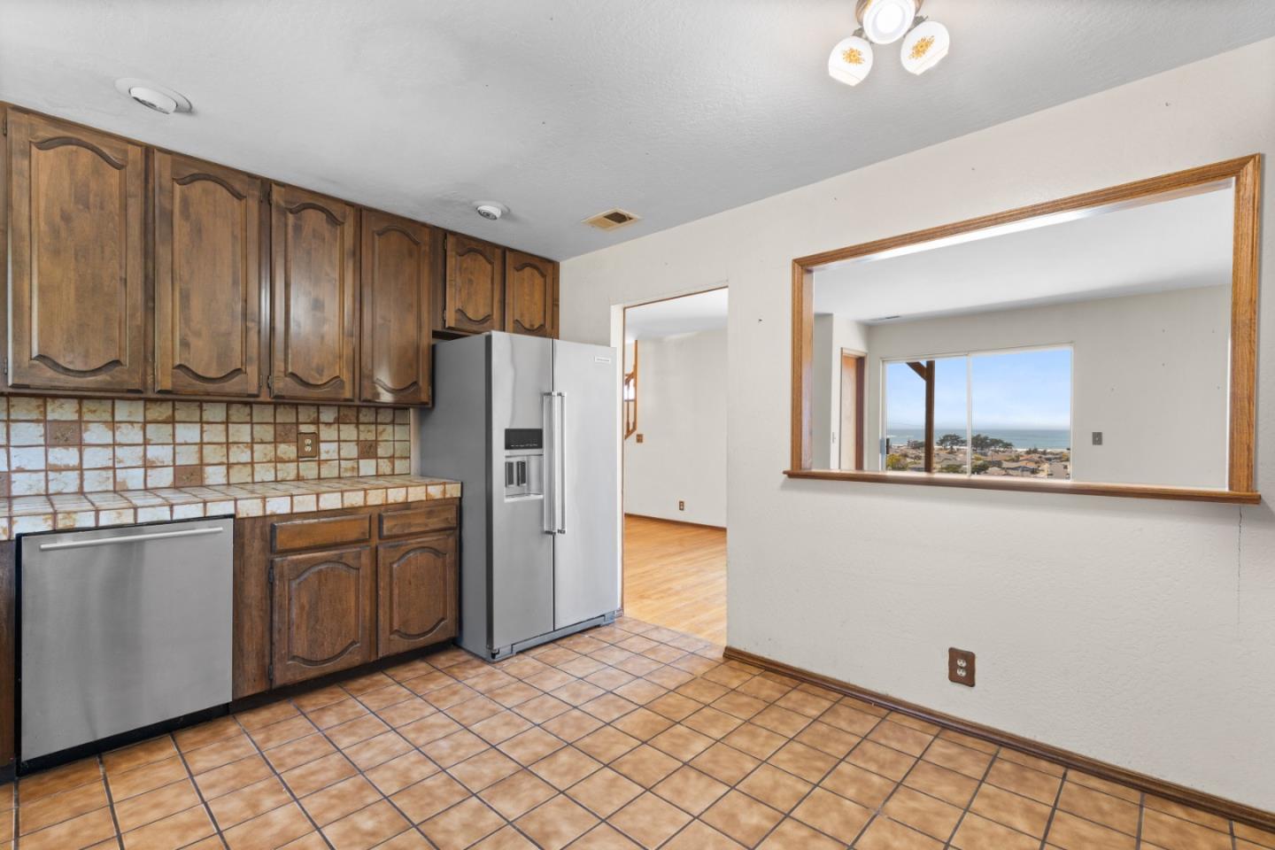 720 Alta Vista Drive Pacifica, CA 94044 - Photo 14 of 40 a kitchen with stainless steel appliances granite countertop a refrigerator and a sink