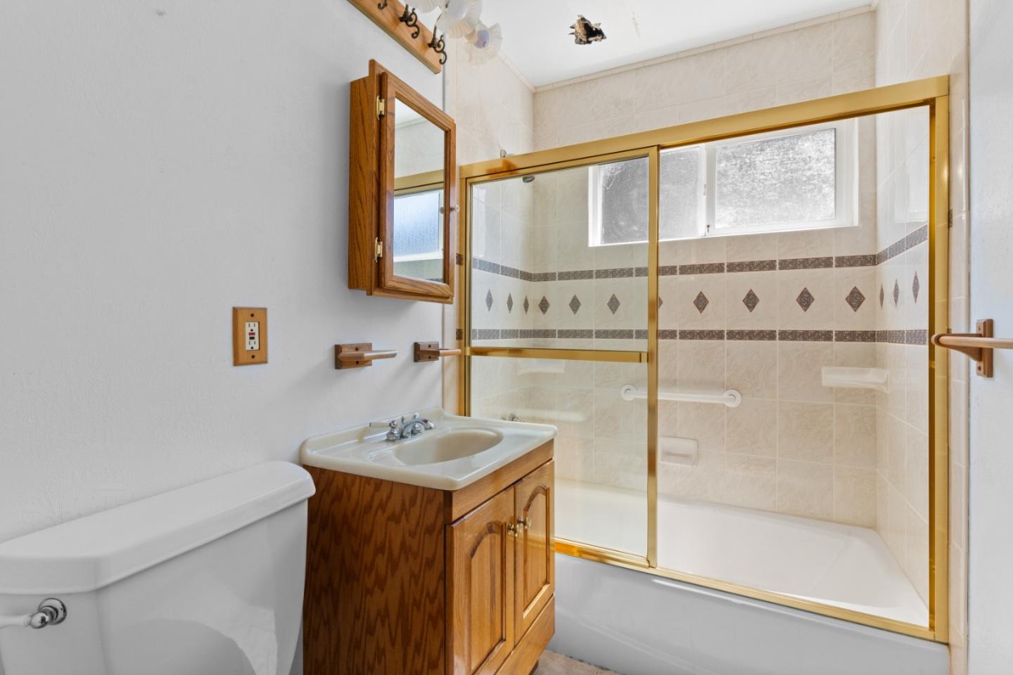 720 Alta Vista Drive Pacifica, CA 94044 - Photo 17 of 40 a bathroom with a sink a mirror and a shower