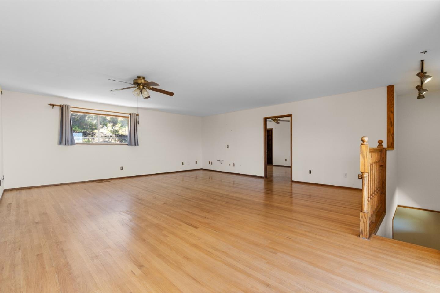 720 Alta Vista Drive Pacifica, CA 94044 - Photo 18 of 40 an empty room with wooden floor and window