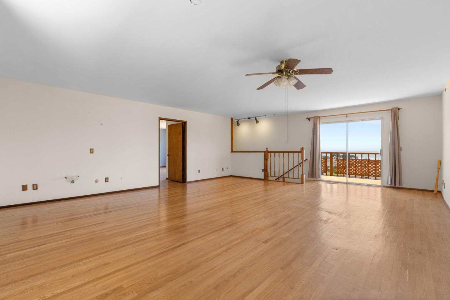720 Alta Vista Drive Pacifica, CA 94044 - Photo 19 of 40 an empty room with wooden floor and windows
