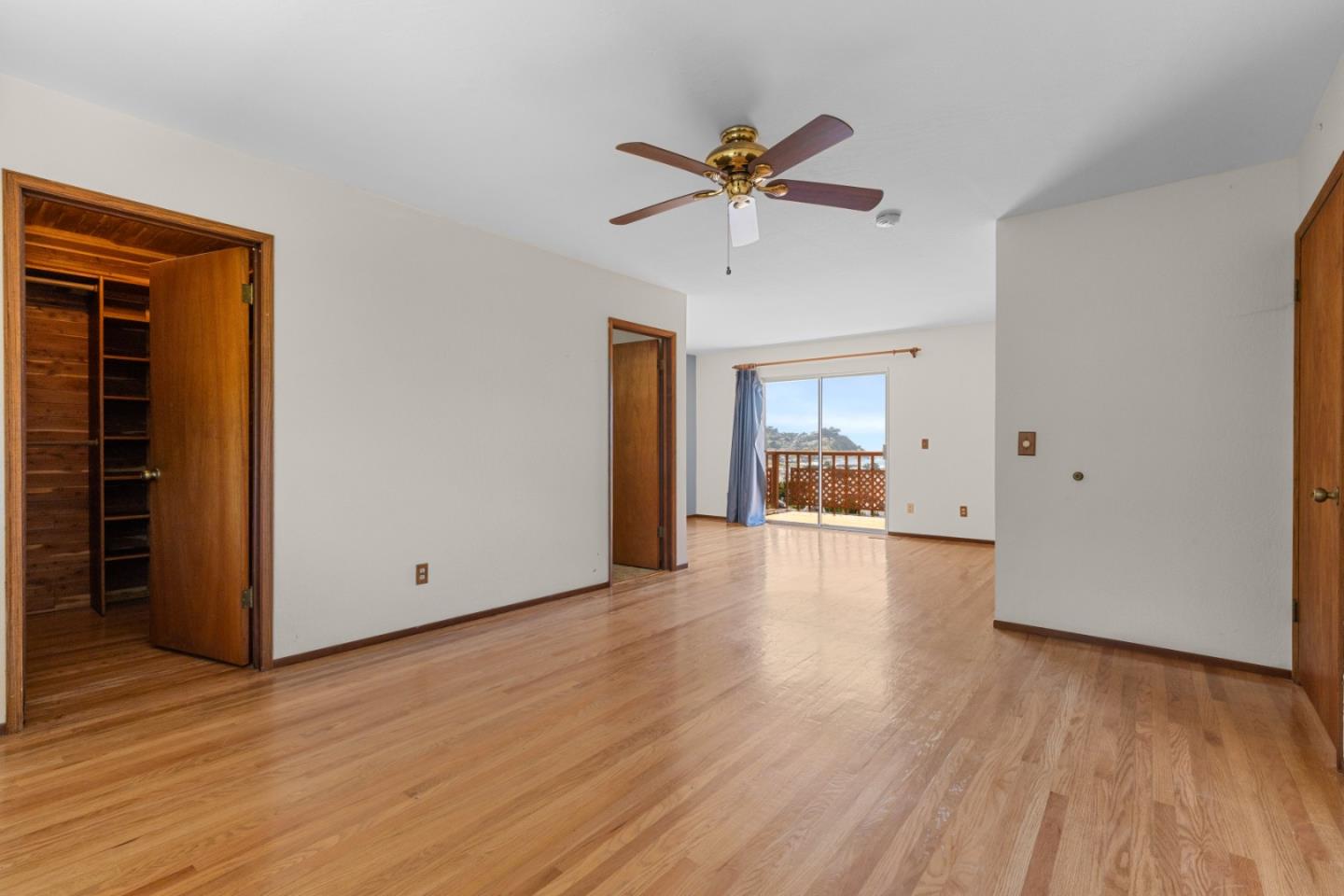 720 Alta Vista Drive Pacifica, CA 94044 - Photo 20 of 40 a view of a livingroom with wooden floor and a ceiling fan