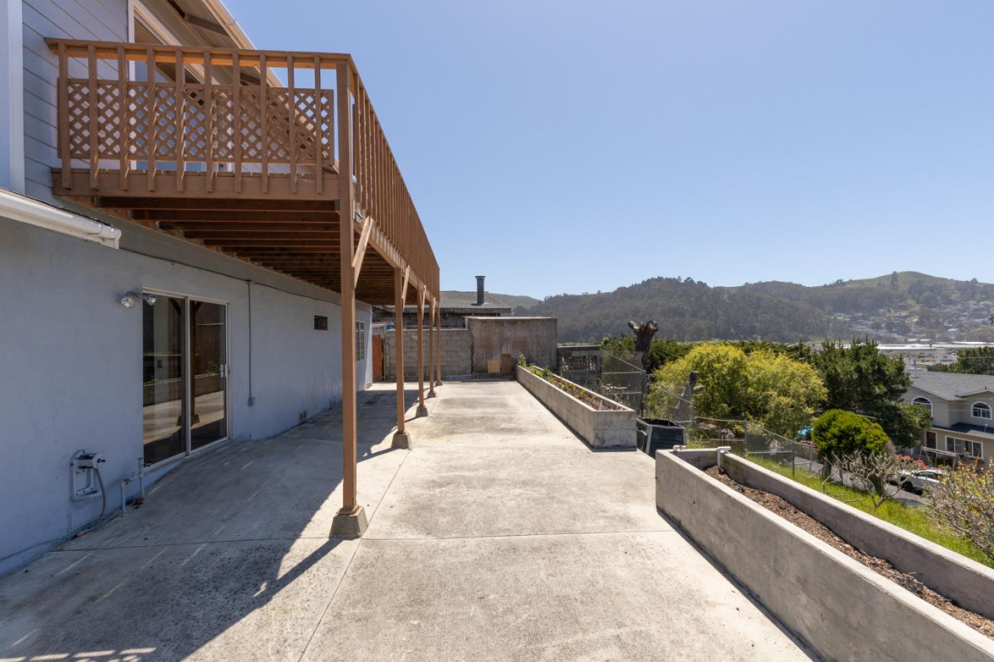 720 Alta Vista Drive Pacifica, CA 94044 - Photo 26 of 40 a view of a house with a balcony and car parked