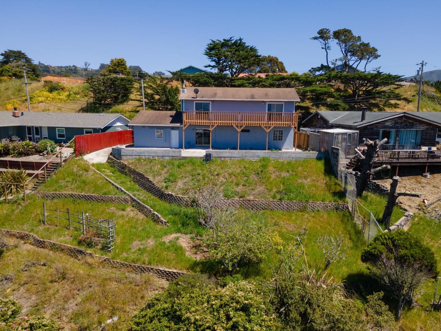 720 Alta Vista Drive Pacifica, CA 94044 - Photo 30 of 40 a view of a house with a yard