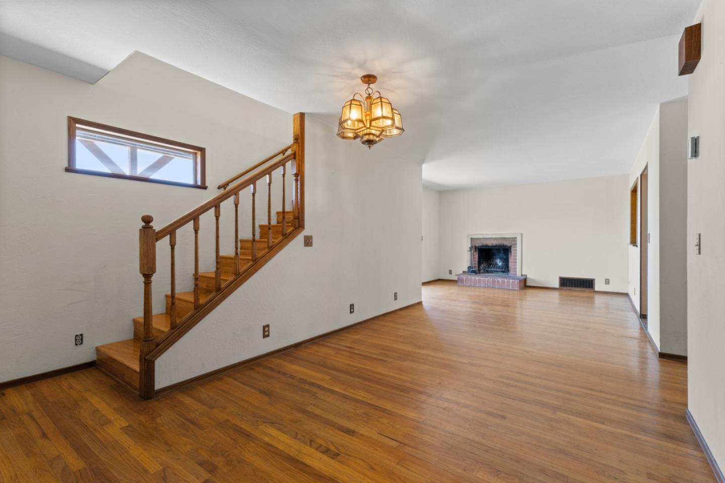 720 Alta Vista Drive Pacifica, CA 94044 - Photo 8 of 40 a view of empty room with wooden floor and fan