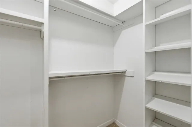 a room with a closet and wooden floor