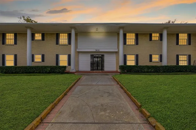 a front view of a building with garden