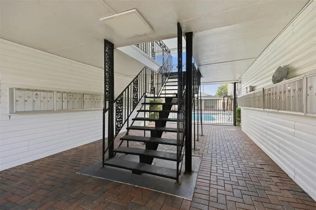 a view of a house with swimming pool and sitting area