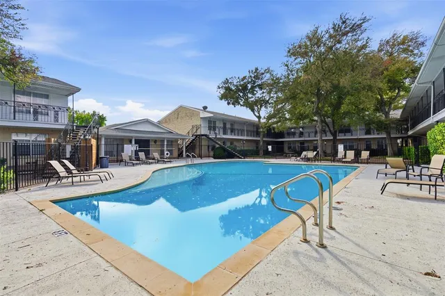 a view of a patio with table and chairs and wooden fence