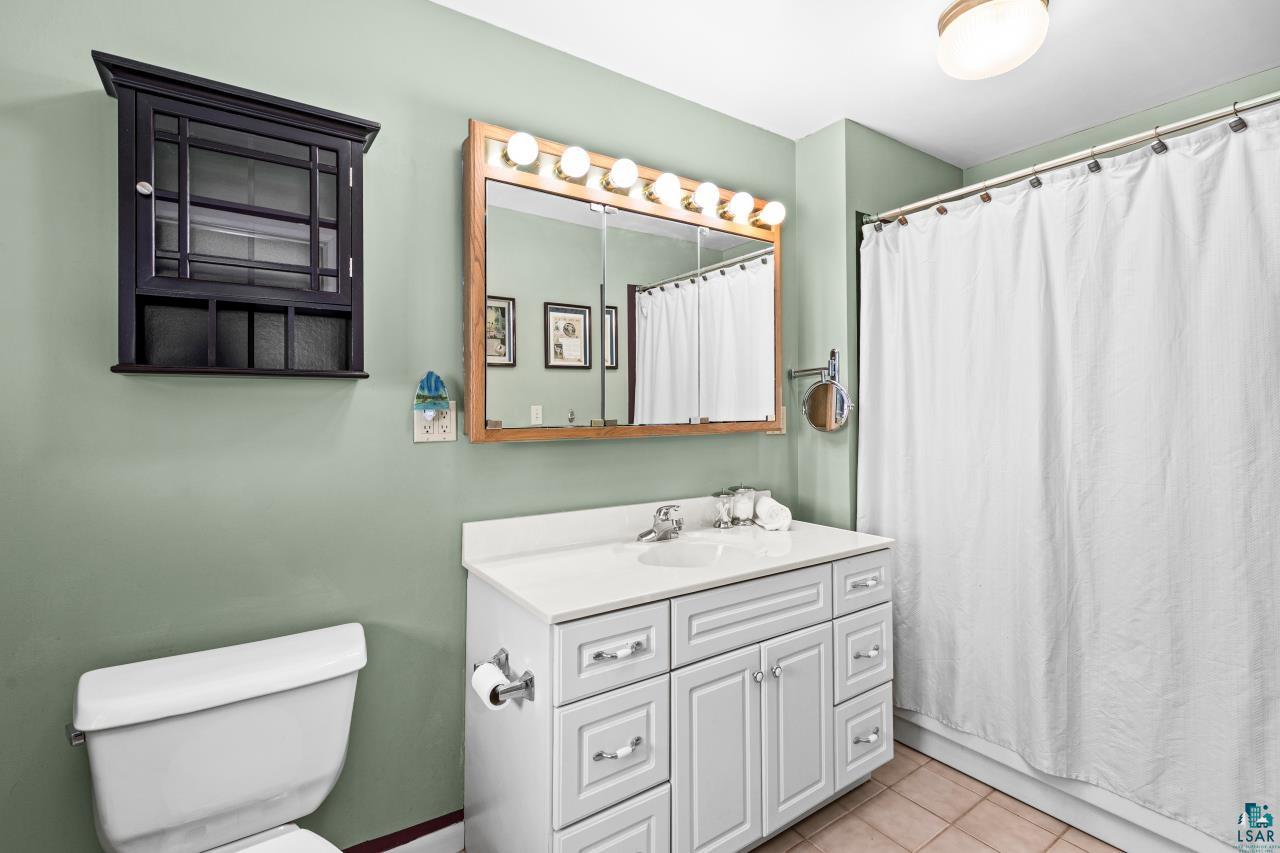 2170 Lester River Road Duluth, MN 55804 - Photo 42 of 66 Bathroom with vanity and light tile patterned floors