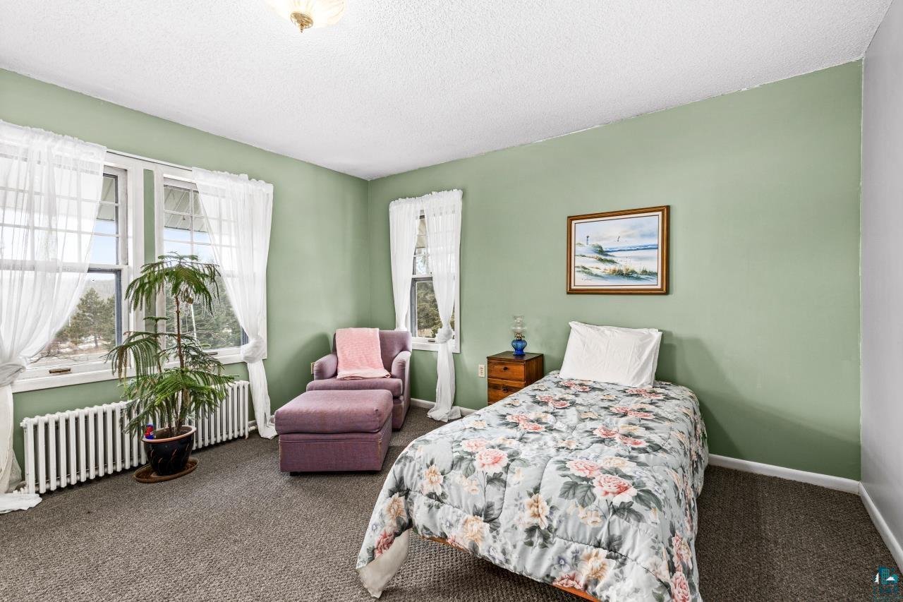 2170 Lester River Road Duluth, MN 55804 - Photo 54 of 66 Bedroom with carpet, radiator heating unit, and a textured ceiling