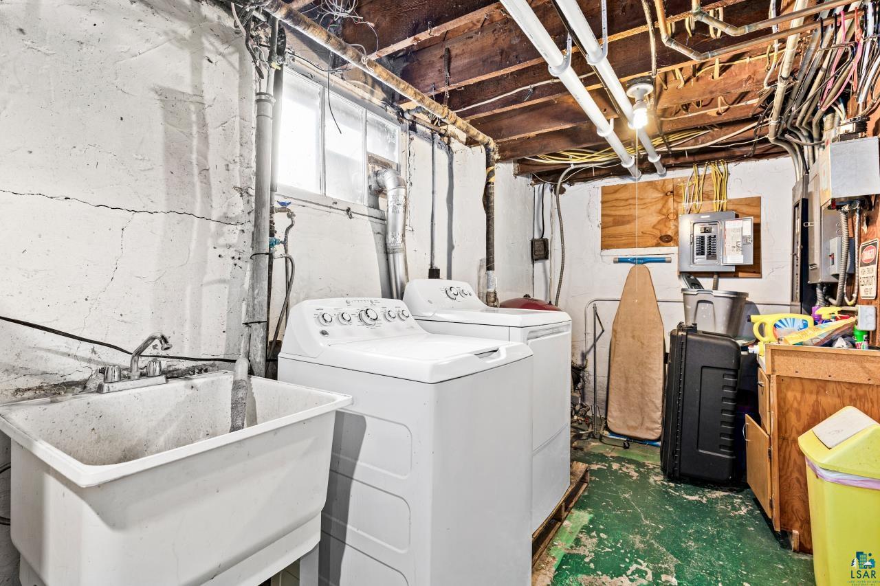 2170 Lester River Road Duluth, MN 55804 - Photo 66 of 66 Laundry area with concrete floors, electric panel, and washer and clothes dryer