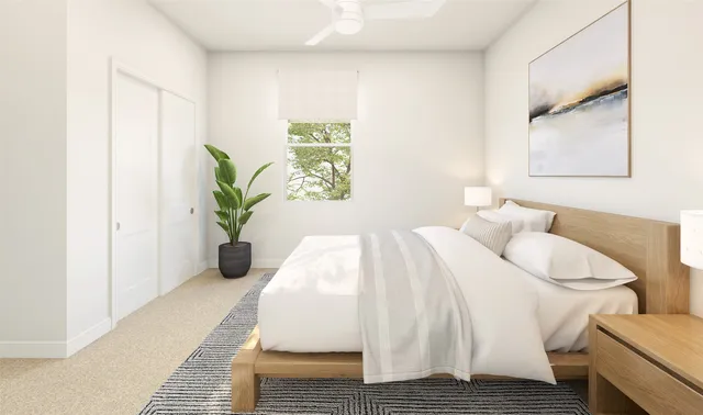 a spacious bedroom with a bed and a window