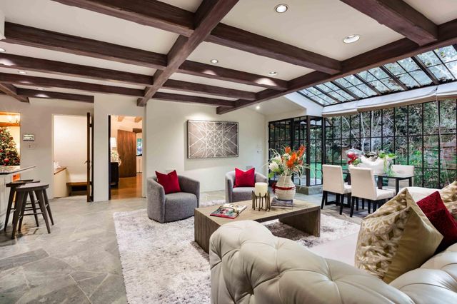 a living room with furniture and a potted plant