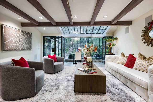 a living room with furniture and a chandelier