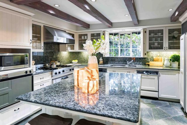 a kitchen with counter top space cabinets and appliances